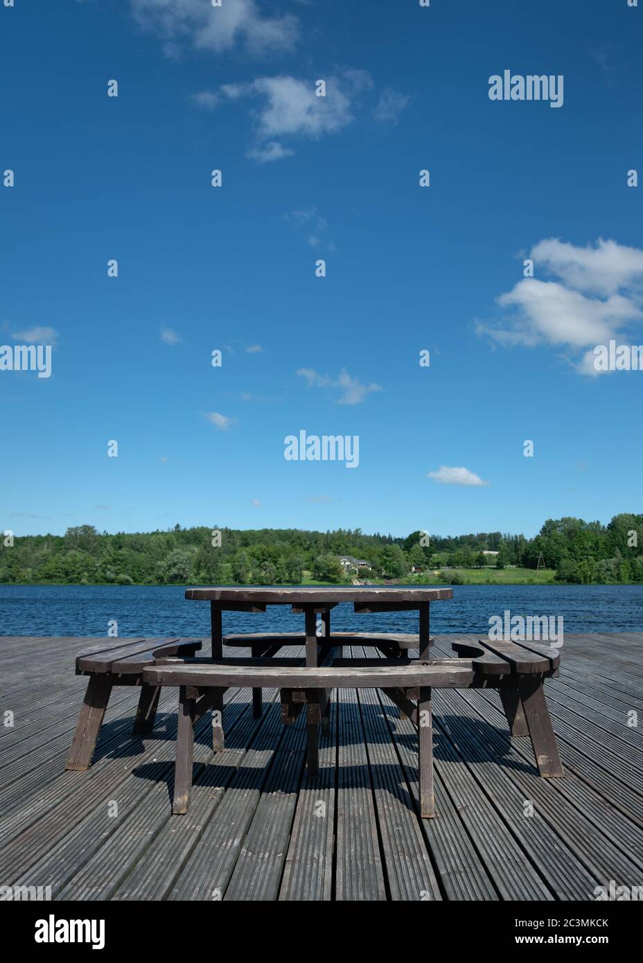 Picnic table on wooden platform ar the river Stock Photo - Alamy