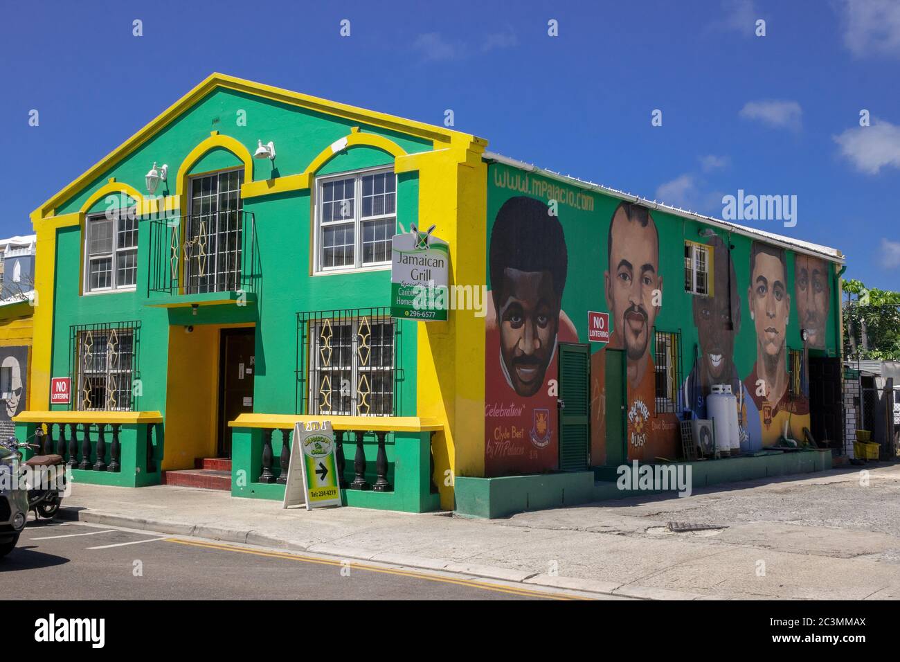 Jamaican Grill Restaurant Hamilton Bermuda With A Mural Of Famous Jamaican Footballers Clyde Best, David Bascome, Shaun Goater, Nahki Wells and Kyle L Stock Photo