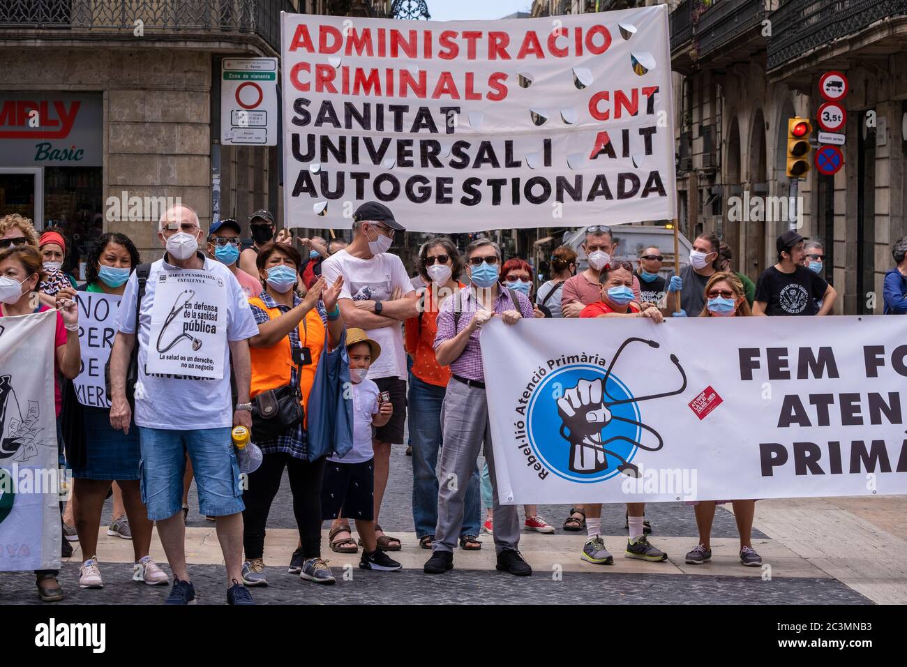 Protesters wearing facemasks are seen with banners denouncing the poor attention of public health services and budget cuts during the demonstration.Convened by the Marea Blanca collective, workers and users of public health have demonstrated against privatization and for the right to public health that truly serves people. Stock Photo