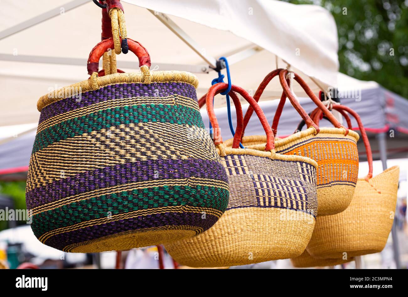 Large West African baskets with leather handles on display at a local