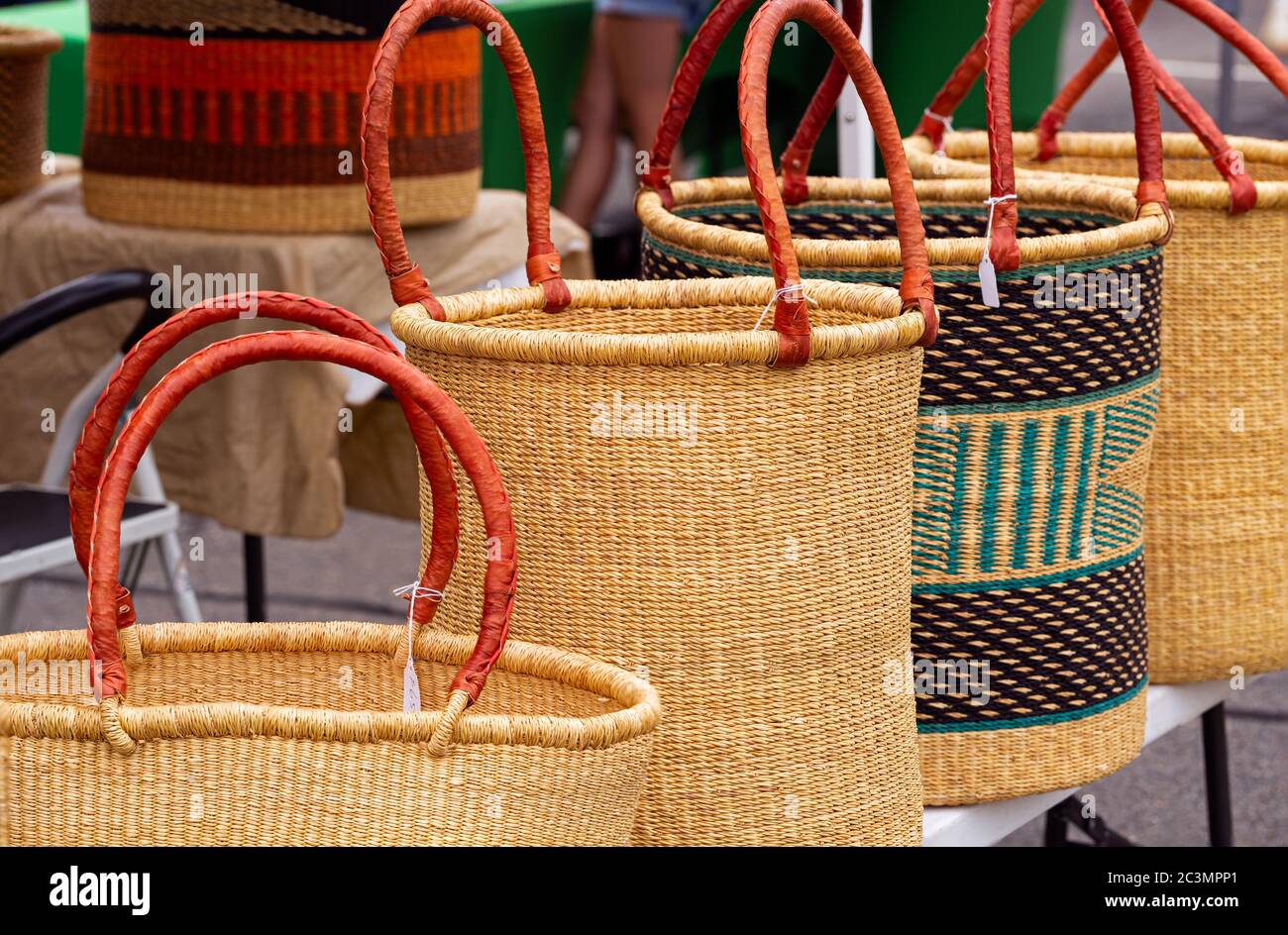 Large West African baskets with leather handles on display at a local