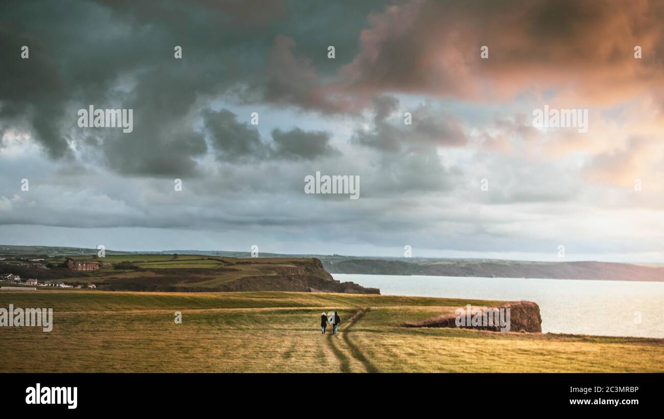 Landscape of cliffs covered in greenery surrounded by the sea under a ...