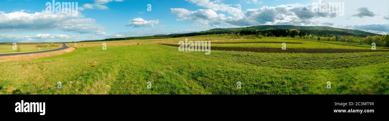 Beautiful rural summer landscape with forest, blue sky and white clouds ...