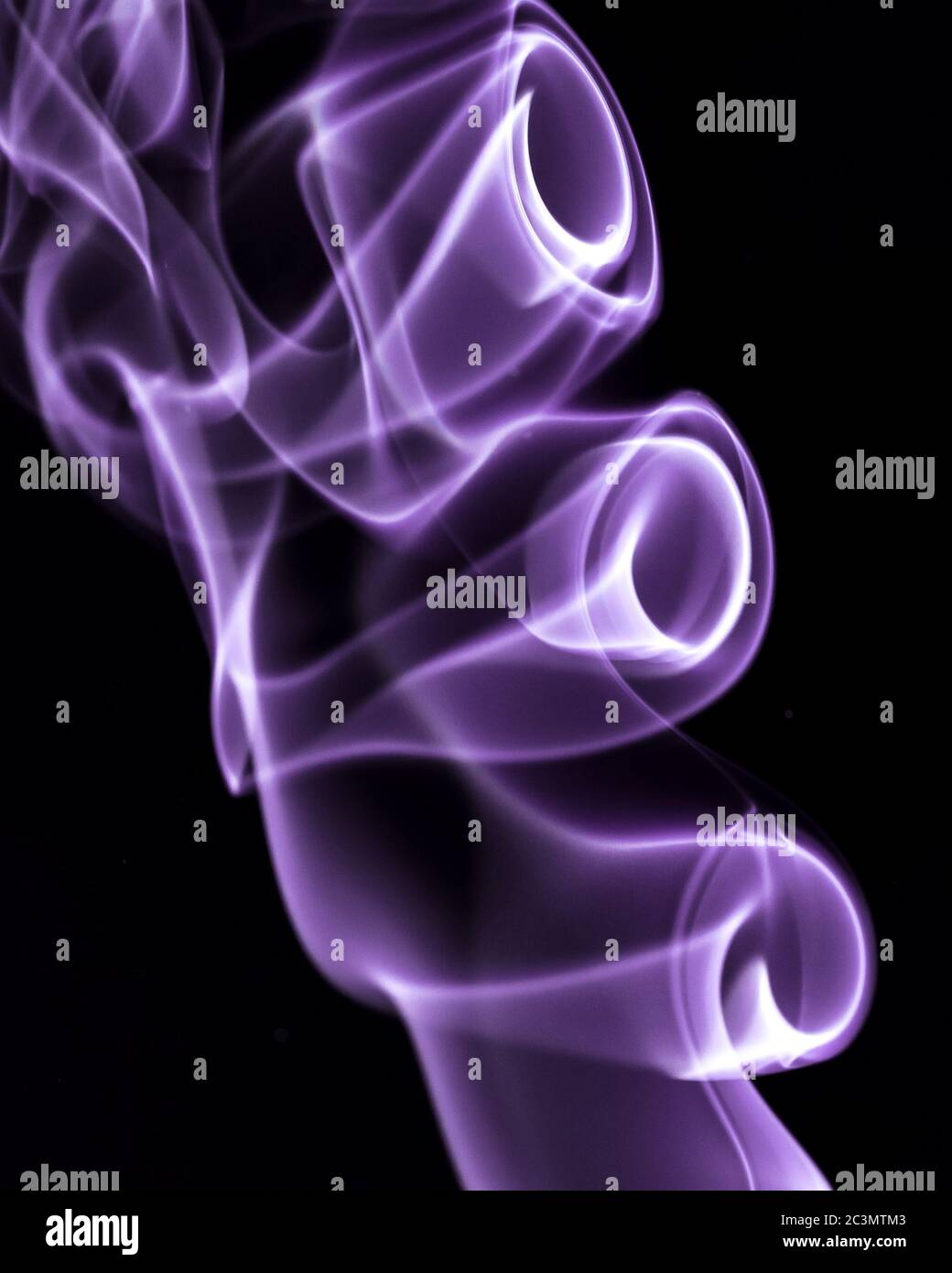 Colourful smoke trails from incense Stock Photo
