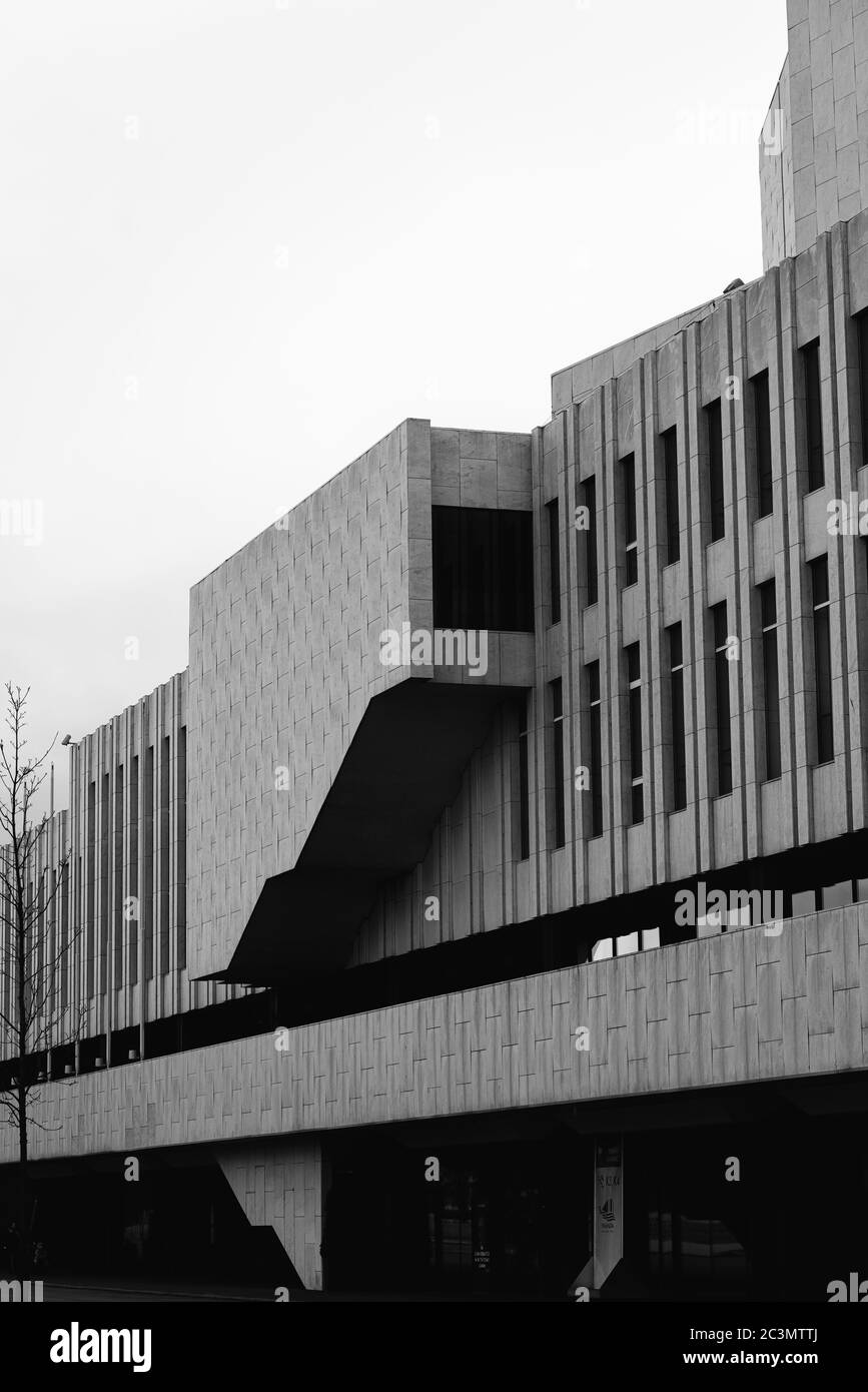 Vertical grayscale shot of the facade of a modern building Stock Photo ...