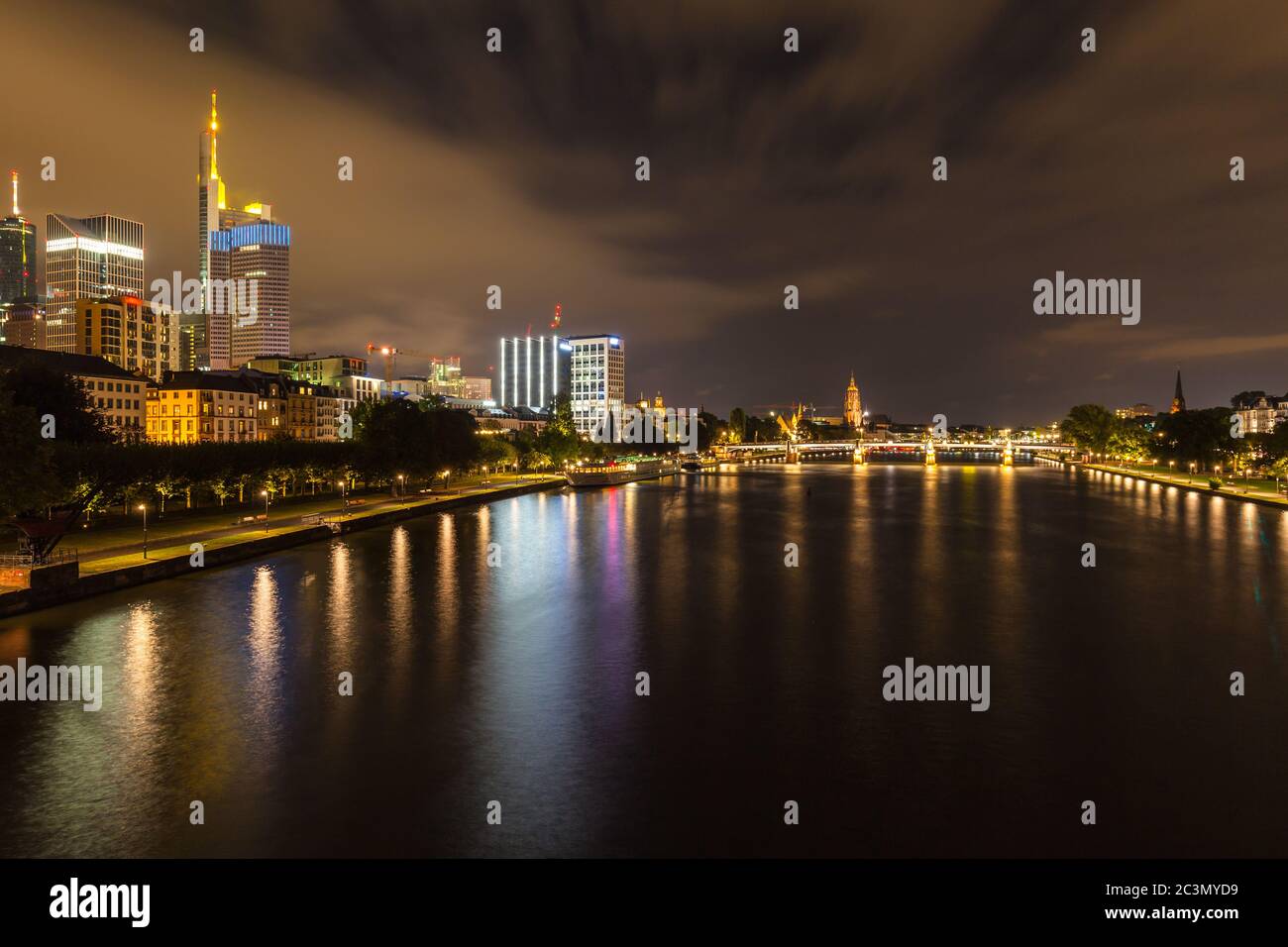 Night view of the skyline of Frankfurt am Main from the Holbeinsteg bridge with the Frankfurt Cathedral in background, Hesse, Germany Stock Photo