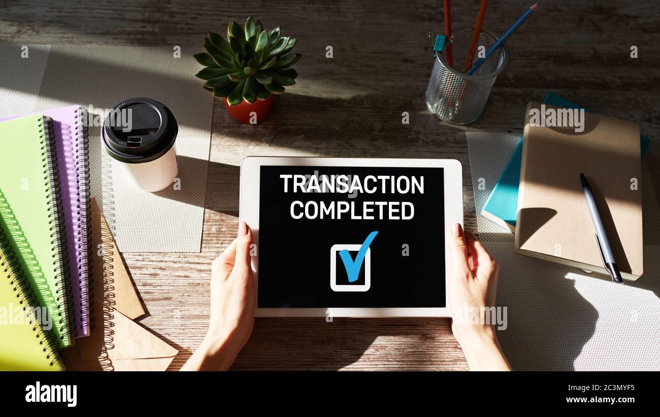 Transacted Complete Transaction completed message on screen. Digital banking and online ...