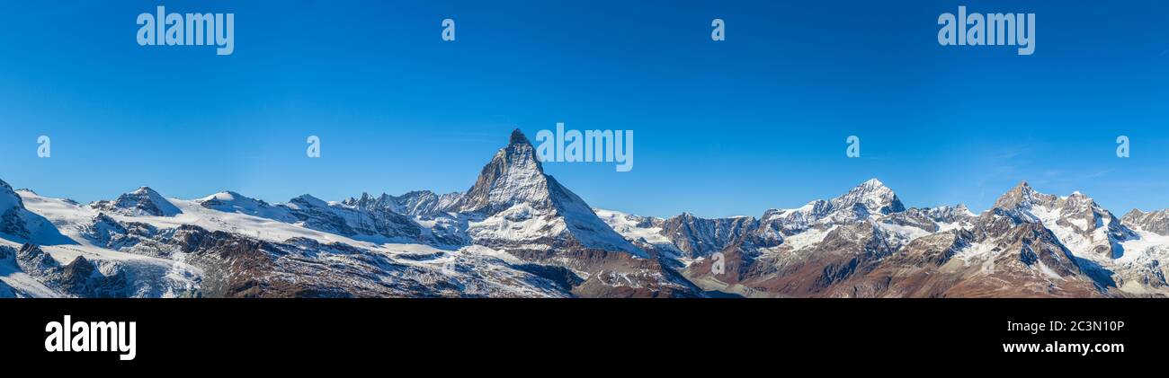 Stunning panorama view of the famous Matterhorn, Weisshorn and Pennine Alps on Swiss Italien border on sunny autumn day with snow and blue sky, from G Stock Photo