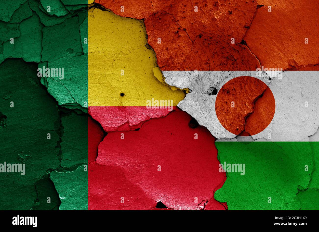 flags of Benin and Niger painted on cracked wall Stock Photo