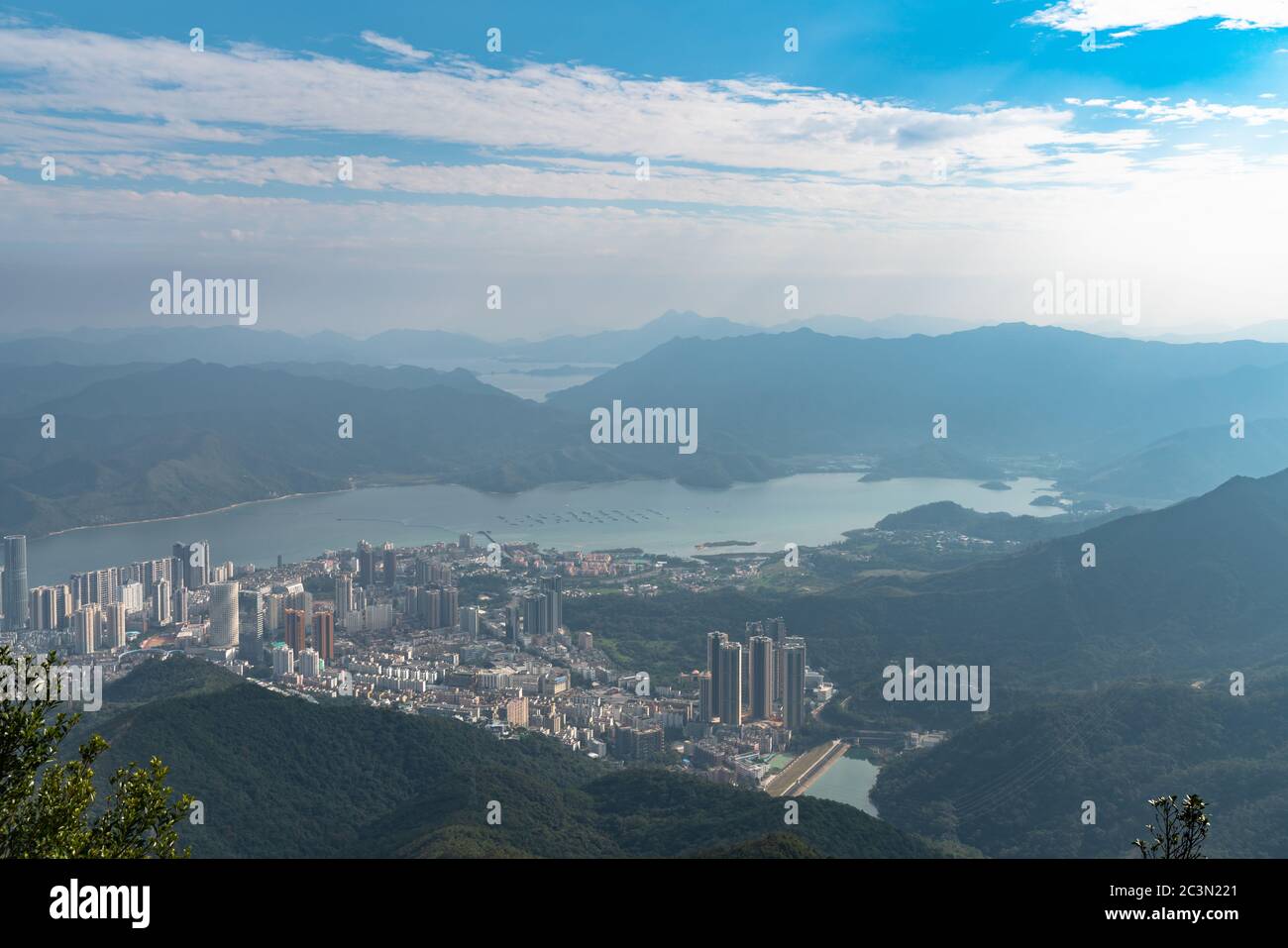 Panorama view of Shenzhen cityscape in direction of Yantian district and Hongkong island from top of Wutong Mountain on a sunny summer day, Guangdong, Stock Photo