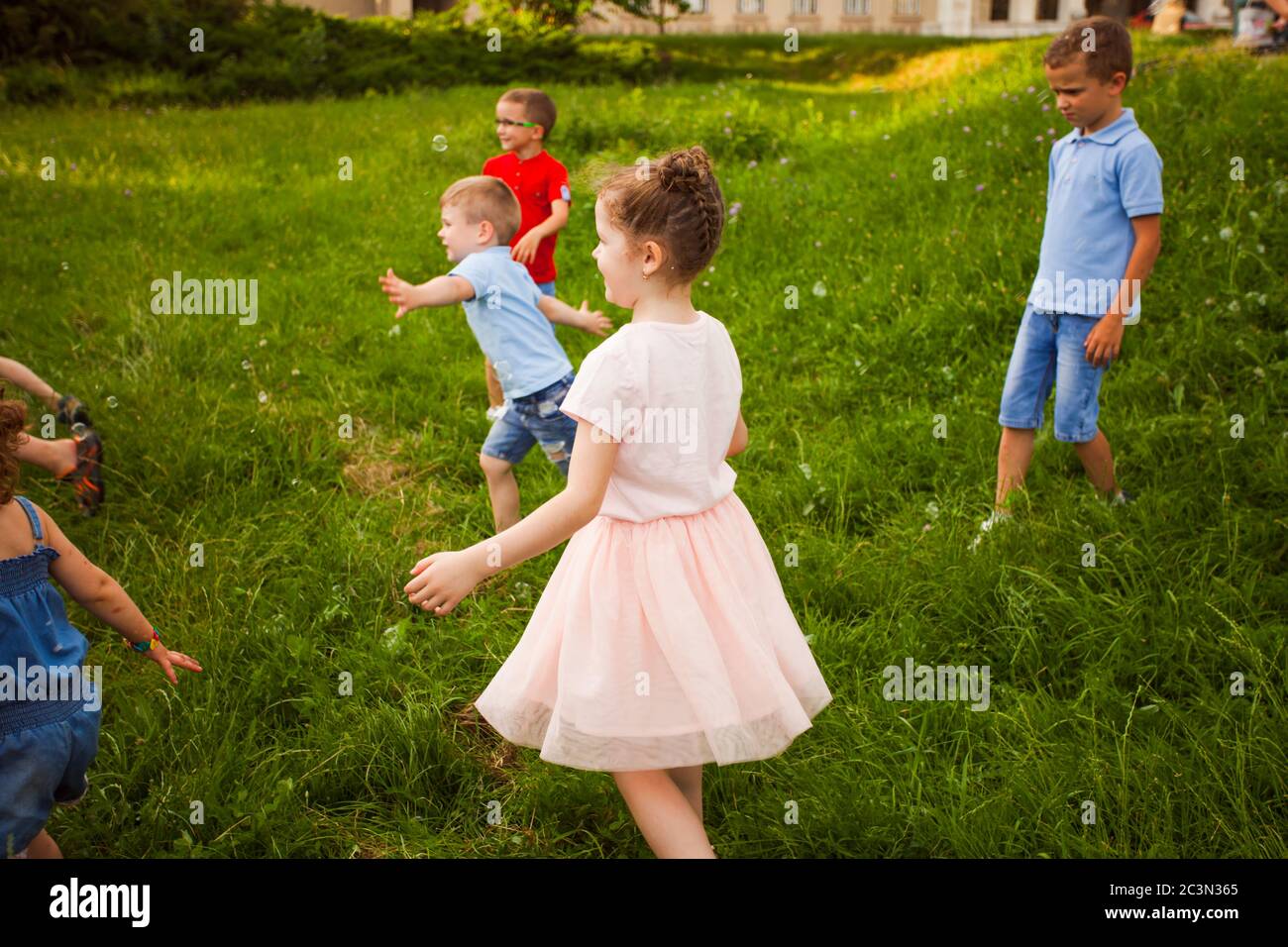 Children playing with soap bubbles in the park Stock Photo - Alamy