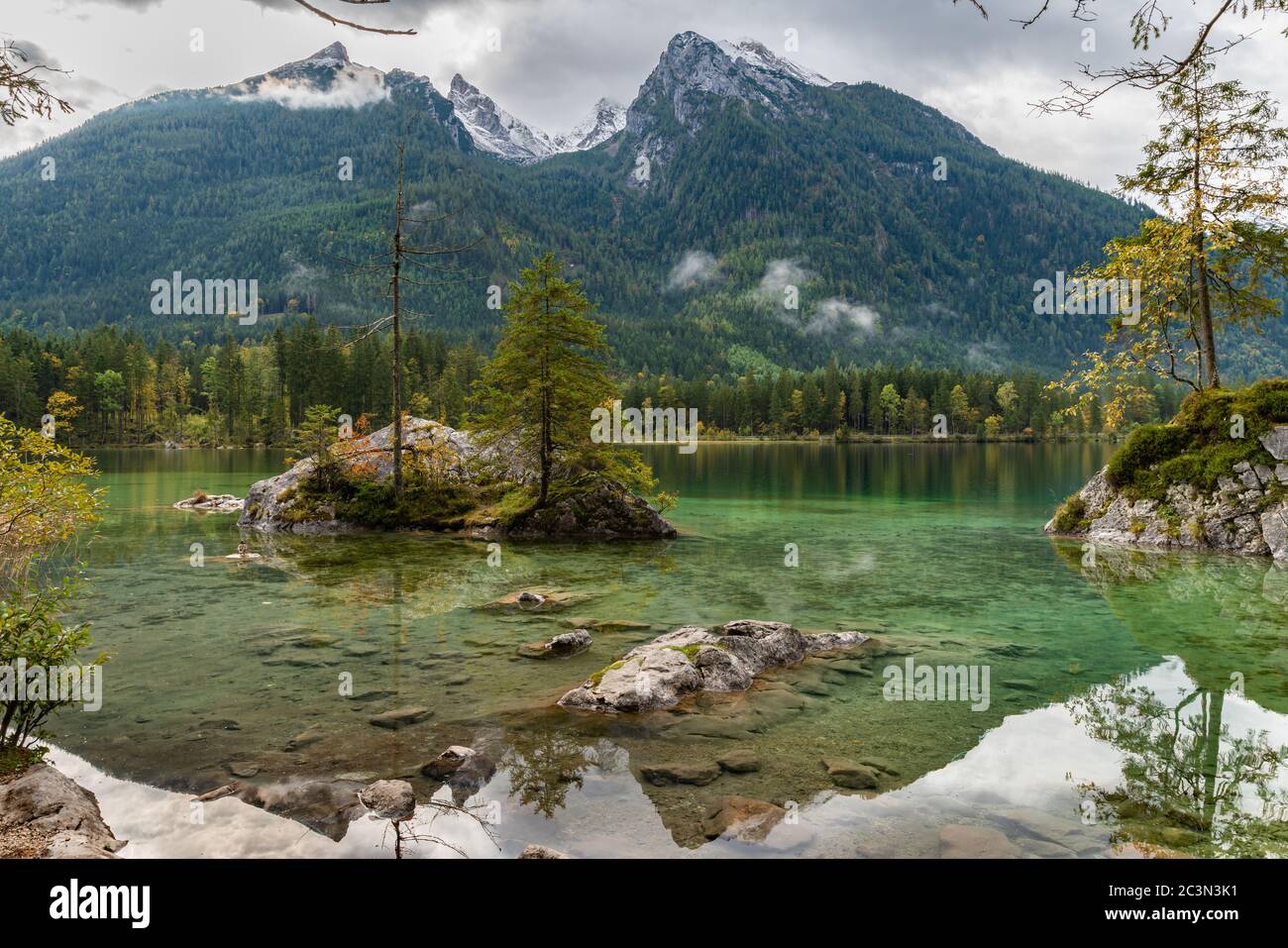Stunning view Hintersee Lake Alps mountain beautiful reflection tree clear water, national park, Konigssee (Koenigssee) lake, Hochkalter Massif backgr Stock Photo