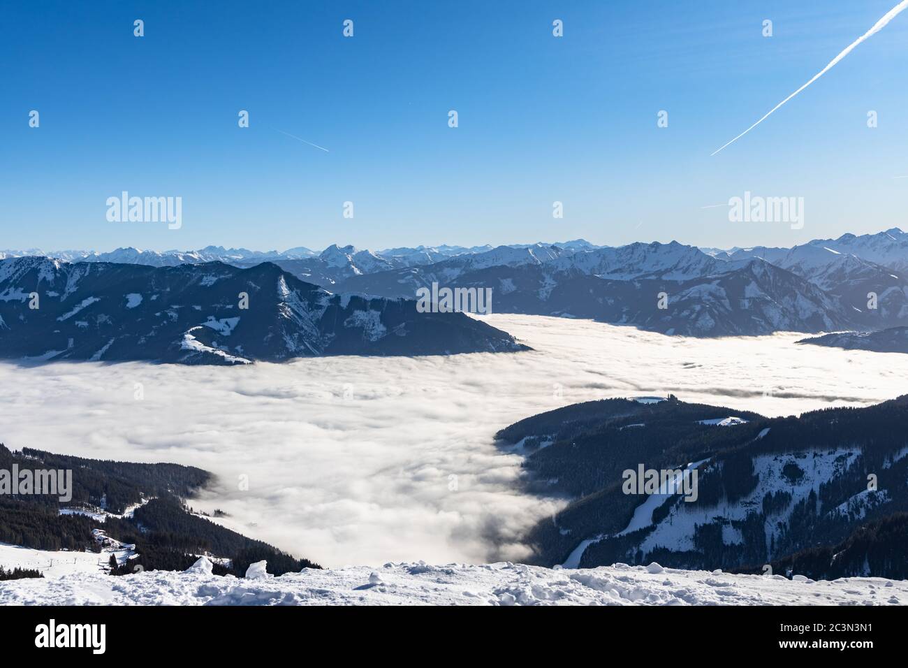Aerial panorama view Salzburg Alps Schimitten mount Schmittenhoehe, Schmittenhohe, Zell am See Kaprun  Lake Zell, blue sky cloud fog, snow Austrian Al Stock Photo