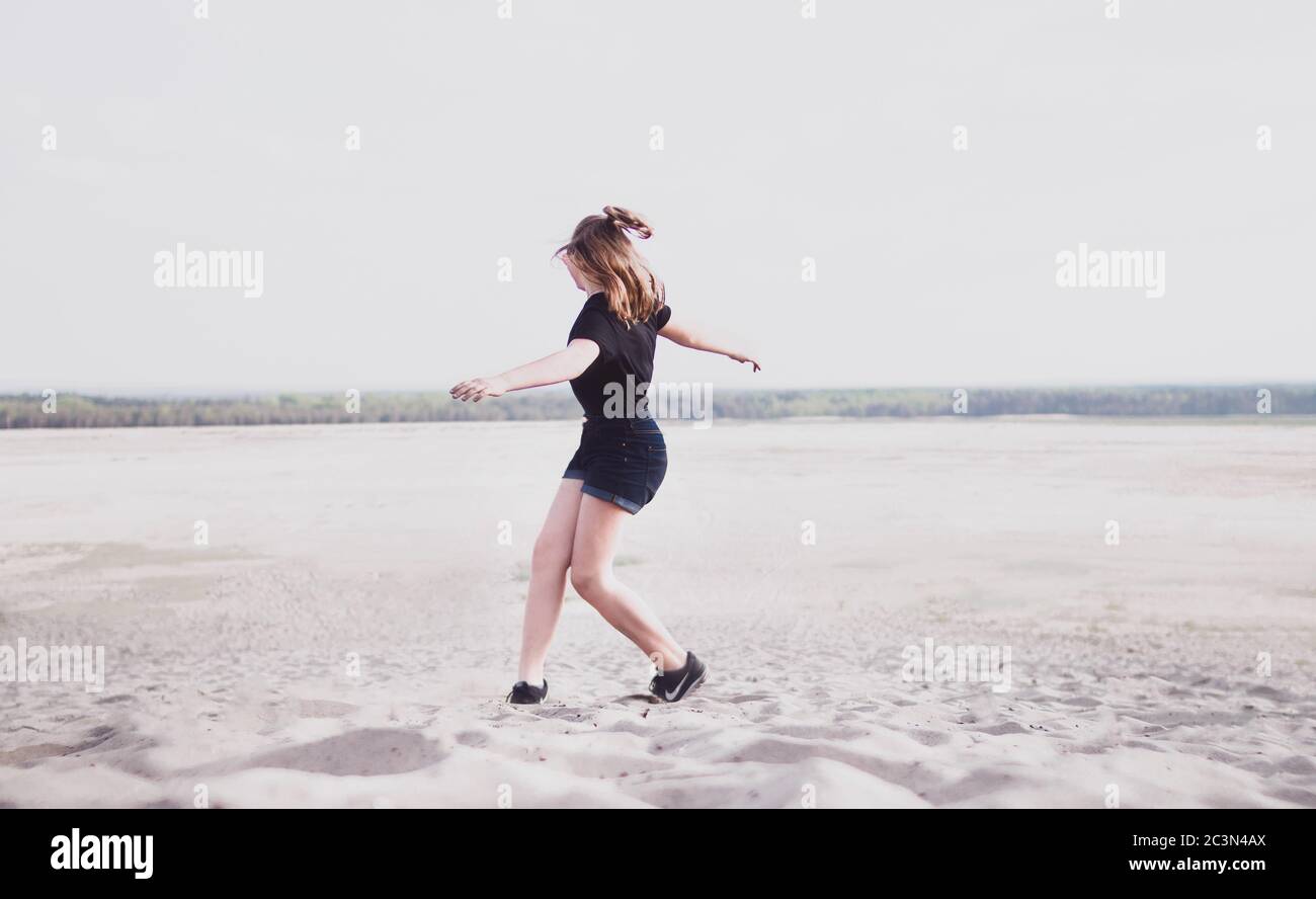 Woman dancing beach jeans hi-res stock photography and images - Alamy