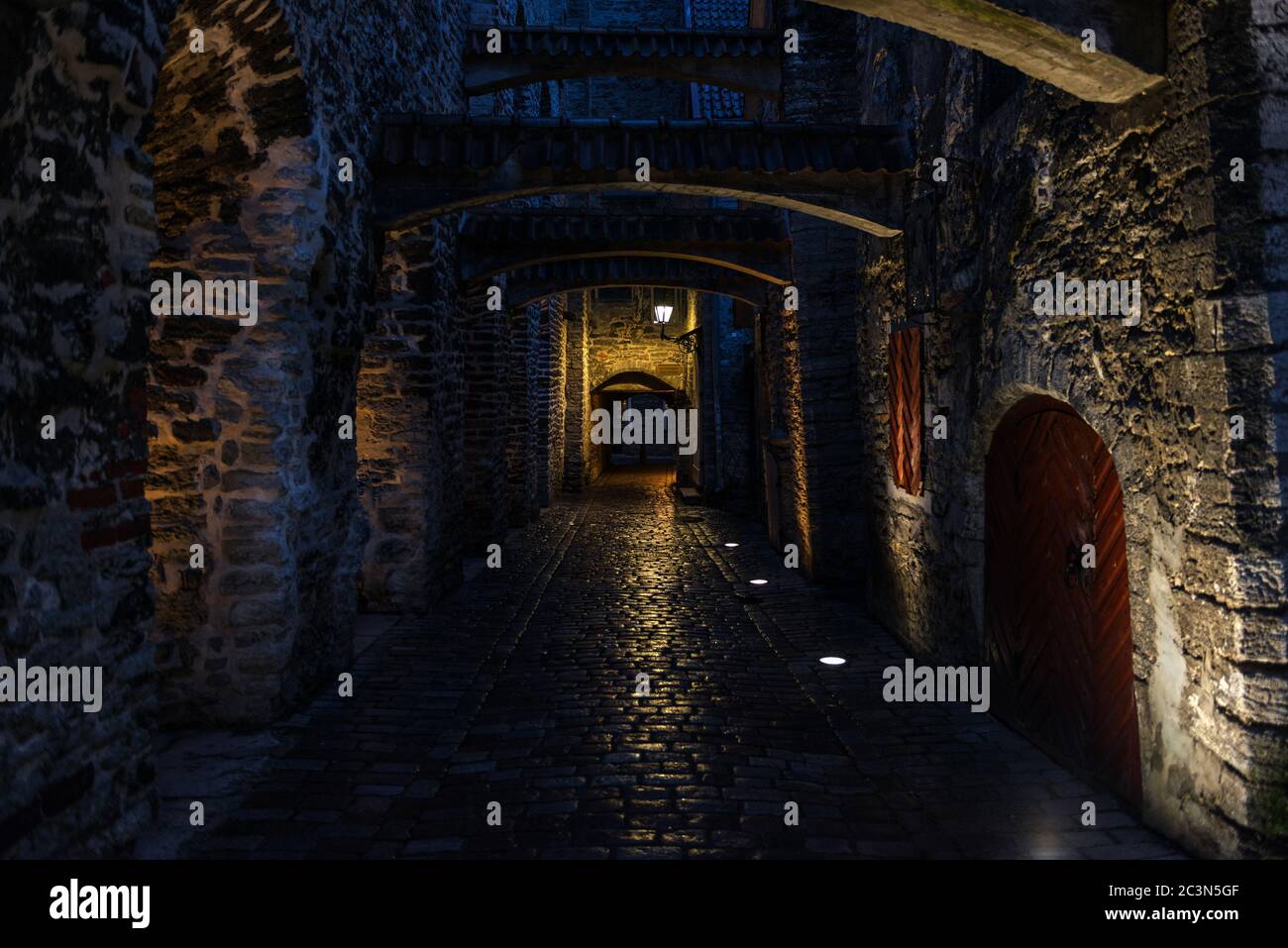 Night view of St. Catherine’s Passage in Tallinn, Estonia, a medieval passage containing some of the old remainings of a Dominican Monastery. Stock Photo