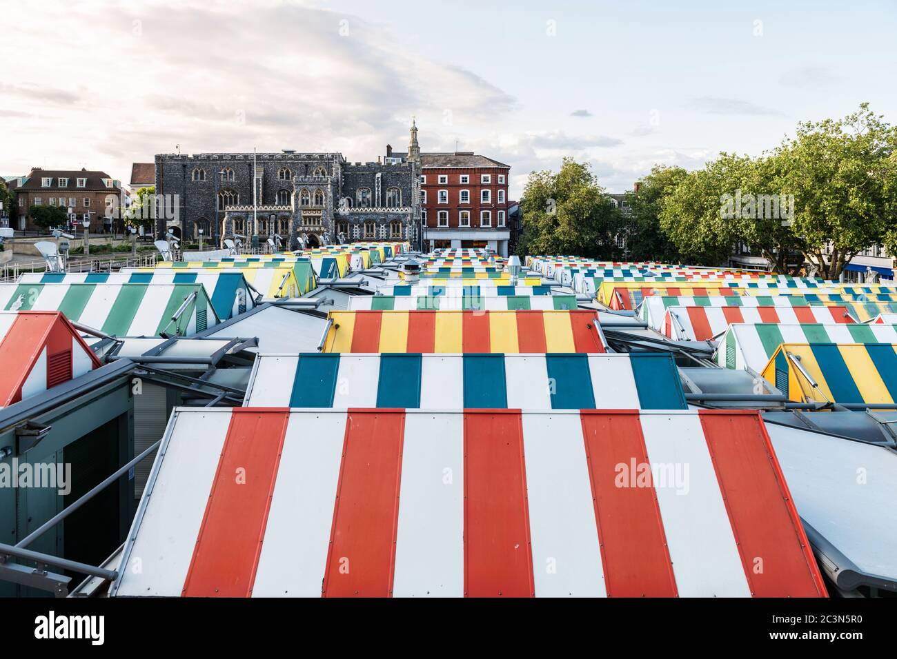 Wide-angle view of the colourful rooftops on Norwich Market, with the medieval Guildhall in the background. Stock Photo