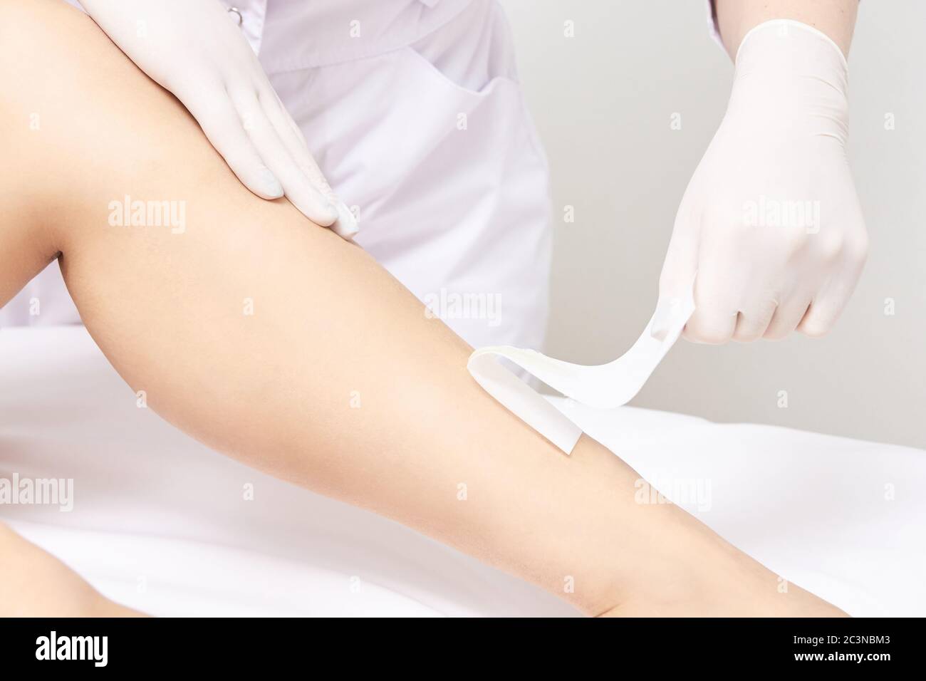 Waxing woman leg. Sugar hair removal. laser service epilation. Salon wax beautician procedure