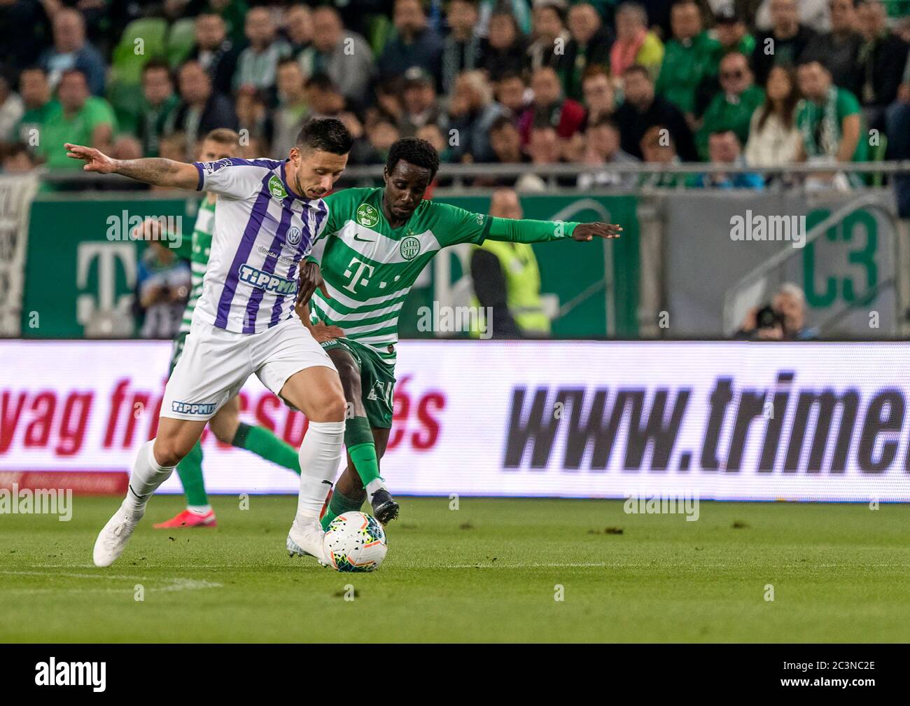 BUDAPEST, HUNGARY - MAY 4: Ihor Kharatin of Ferencvarosi TC #14 blocks the  shot from Vincent Onovo of Ujpest FC (l) before Tokmac Chol Nguen of Ferencvarosi  TC #92 during the Hungarian