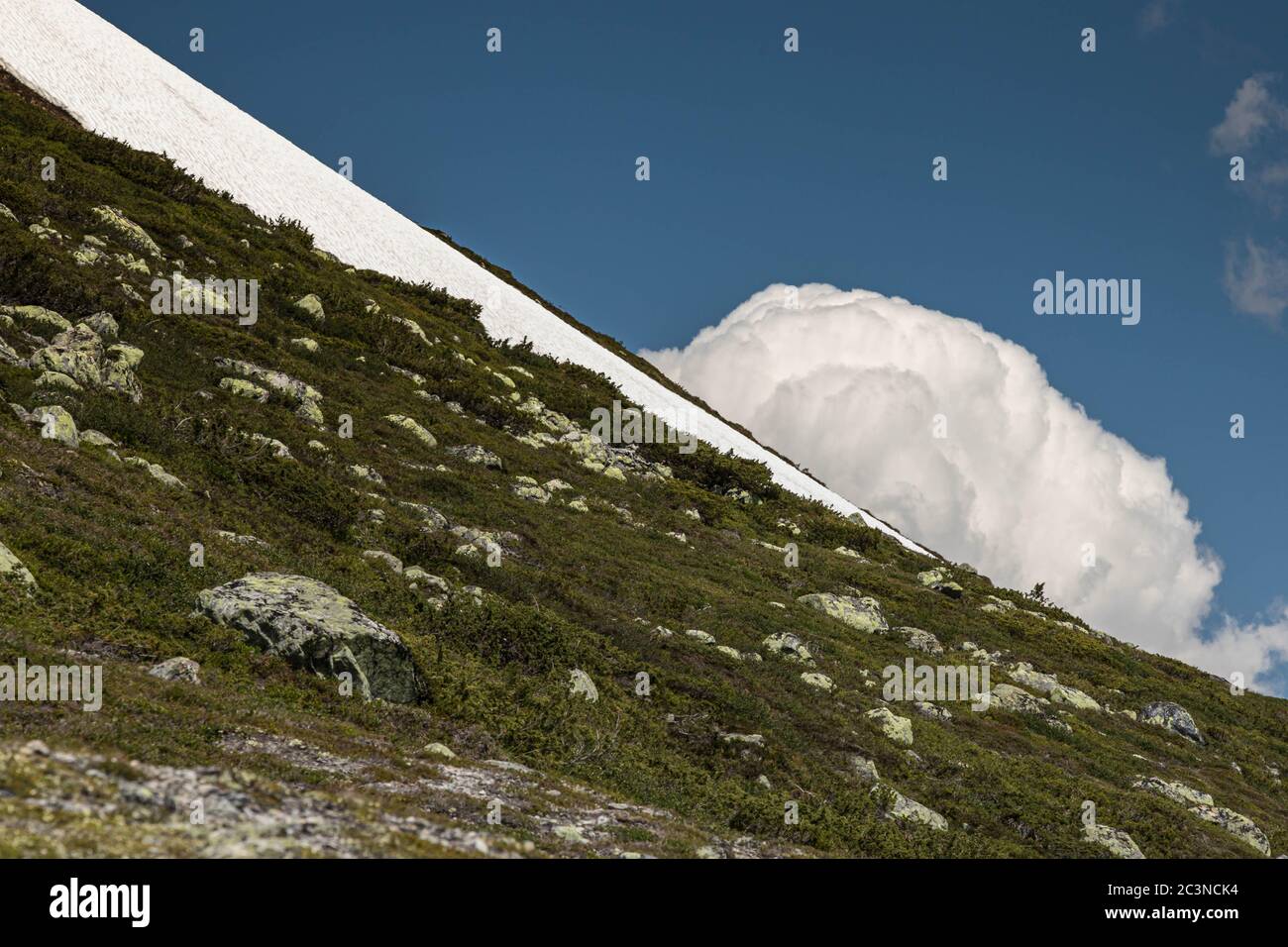 Remains of a glacier, only a small amount of snow left on the mountain side. Stock Photo