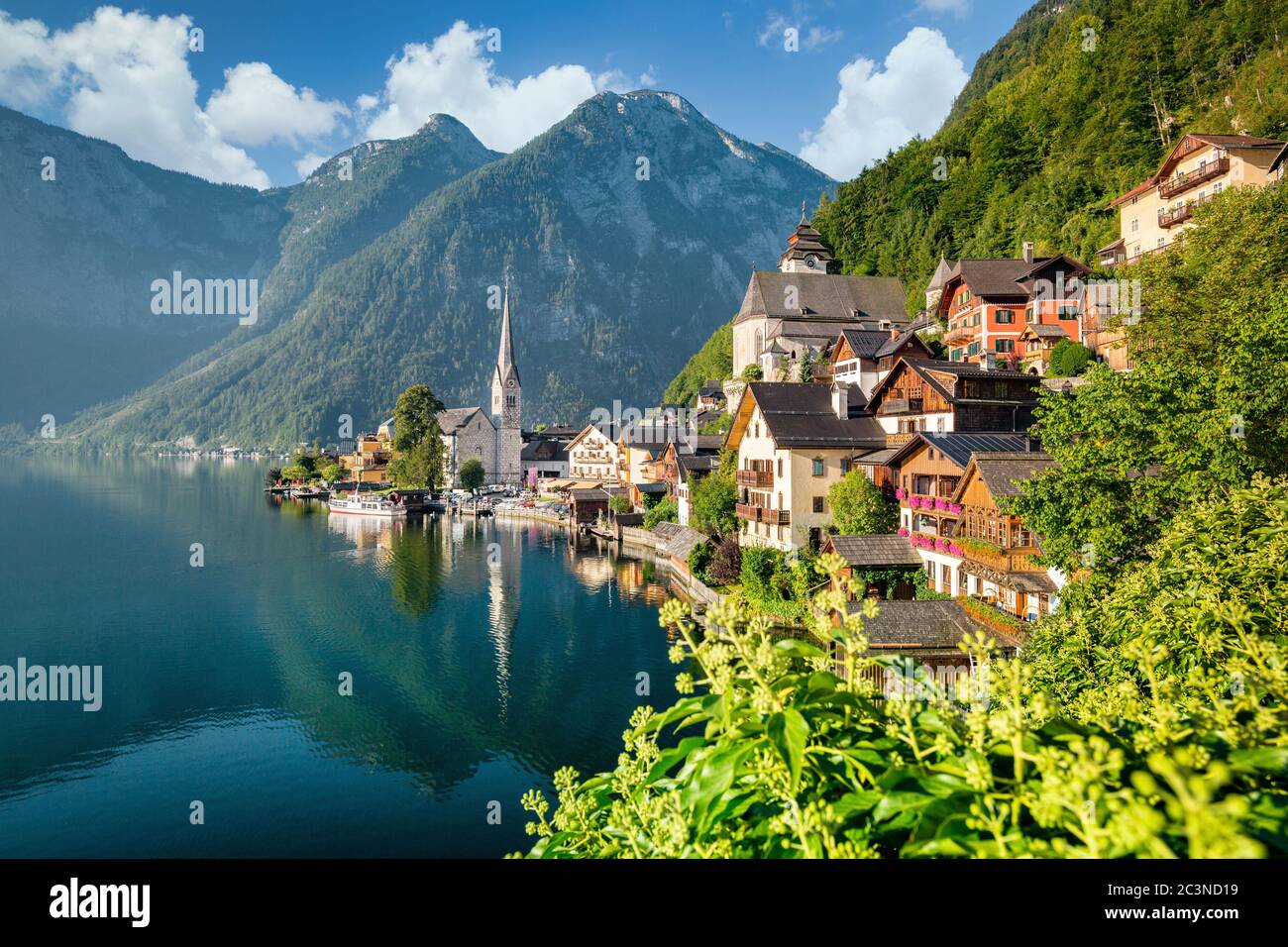 Classic postcard view of famous Hallstatt lakeside town in scenic golden morning light on a beautiful sunny day in summer, Salzkammergut, Austria Stock Photo