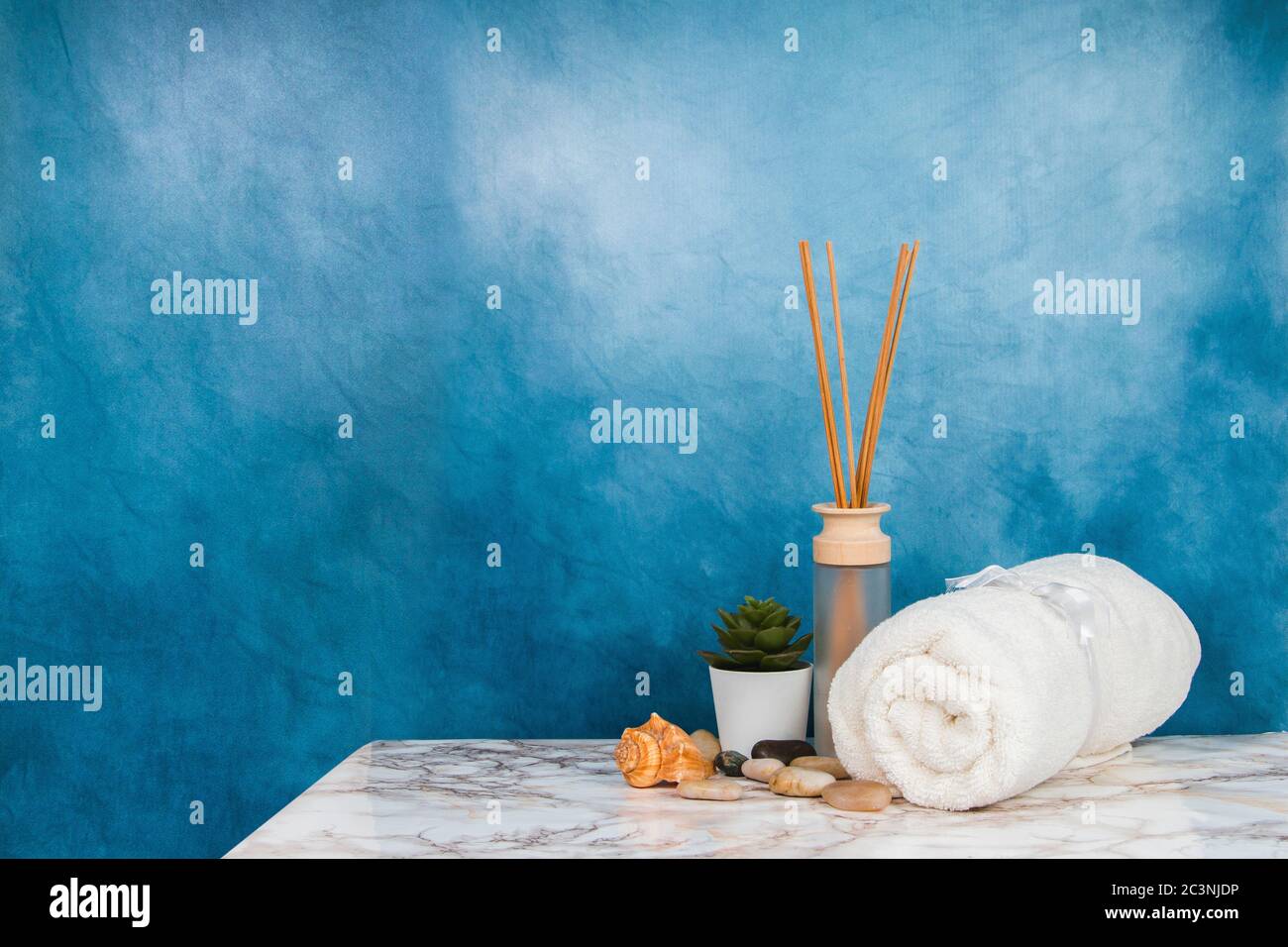 Spa objects and elements on a marble table and blue background Stock Photo