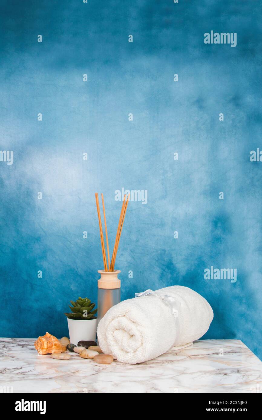 Spa objects and elements on a marble table and blue background Stock Photo