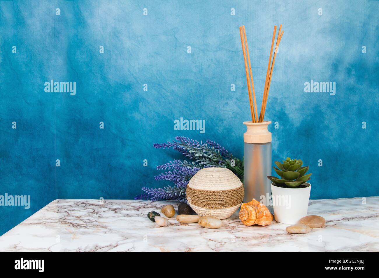 Spa objects and elements on a marble table and blue background Stock Photo