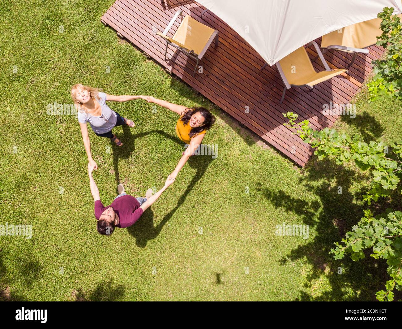 Aerial view of the family with a drone. The family playing roundelay in  their backyard Stock Photo - Alamy