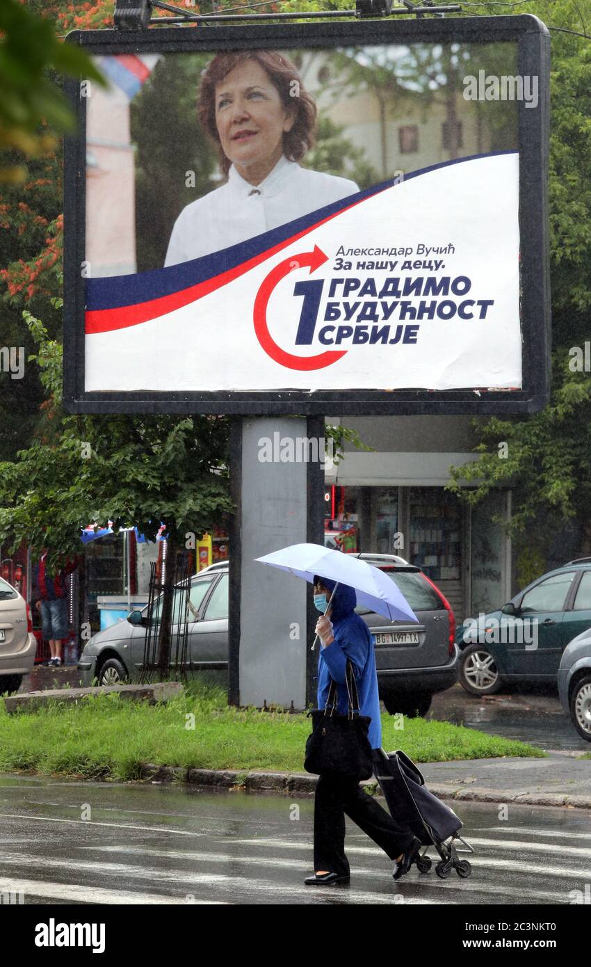 Belgrade, Serbia. 21 June 2020. A woman walks past a campaign billboard of the ruling Serbian Progressive Party (SNS) of incumbent President Aleksandar Vucic, during the parliamentary elections. The Western Balkan nation's voters are set to choose their representatives in the 250-seat National Assembly on 21 June. The balloting was originally scheduled for 26 April, but it was postponed due to the state of emergency declared in a bid to contain the spread of the ongoing pandemic of the COVID-19 disease caused by the SARS-CoV-2 coronavirus. Credit: Koca Sulejmanovic/Alamy Live News Stock Photo