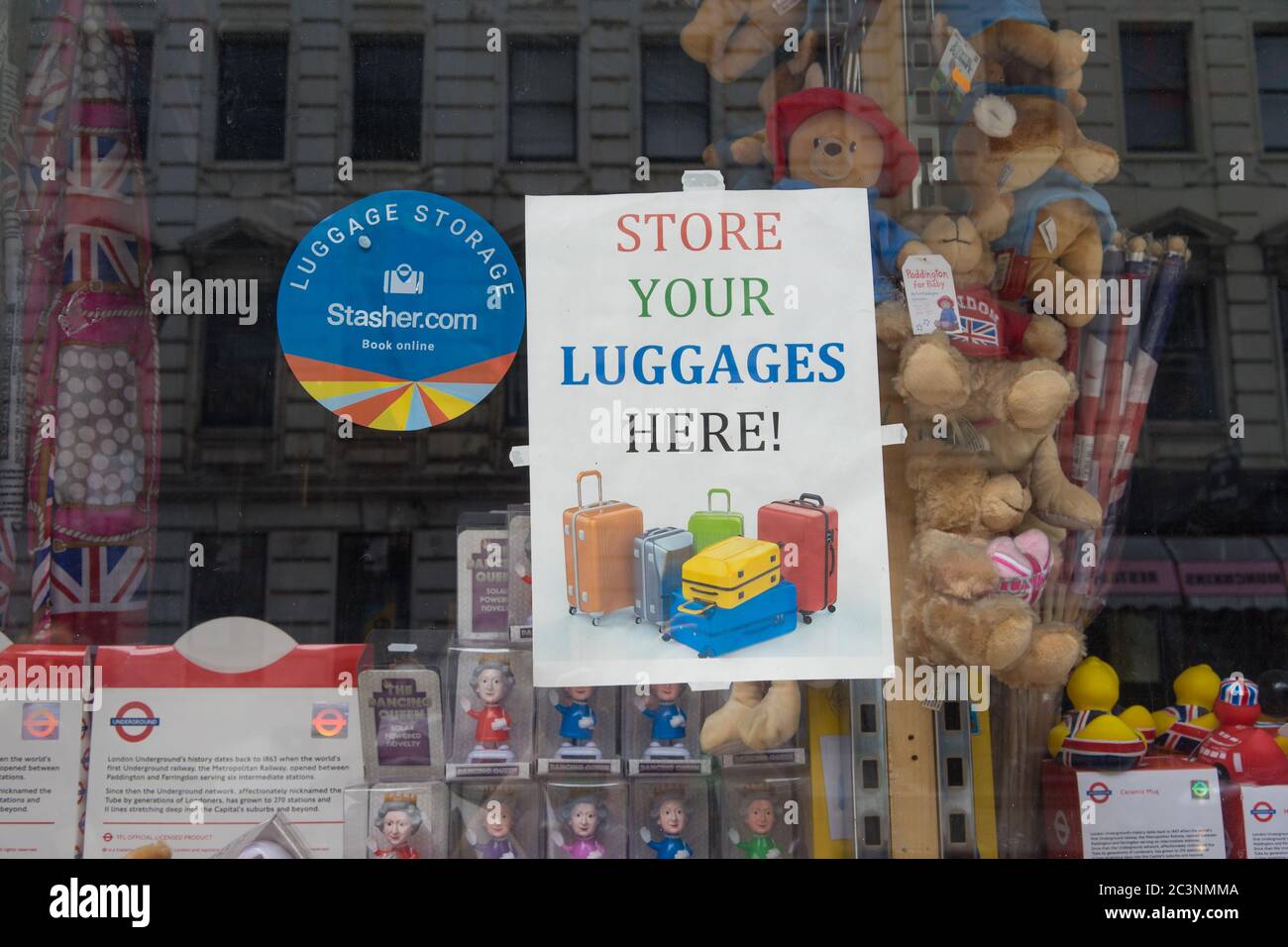 Store you luggage here sign in the window of a souvenir shop. London Stock Photo Alamy