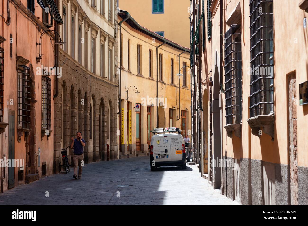 Narrow old cozy street in Lucca, Italy. Lucca is a city and comune in Tuscany. It is the capital of the Province of Lucca Stock Photo