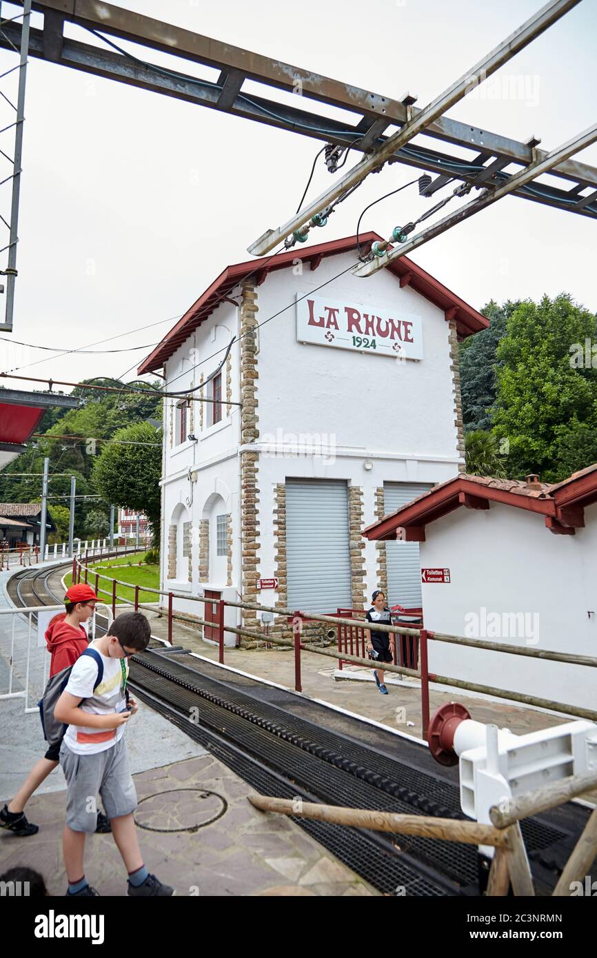 Sare, France - June 21, 2018: The 'Petit Train de La Rhune'', typically Basque Col de Saint-Ignace train station, tourists near authentic cog railway Stock Photo