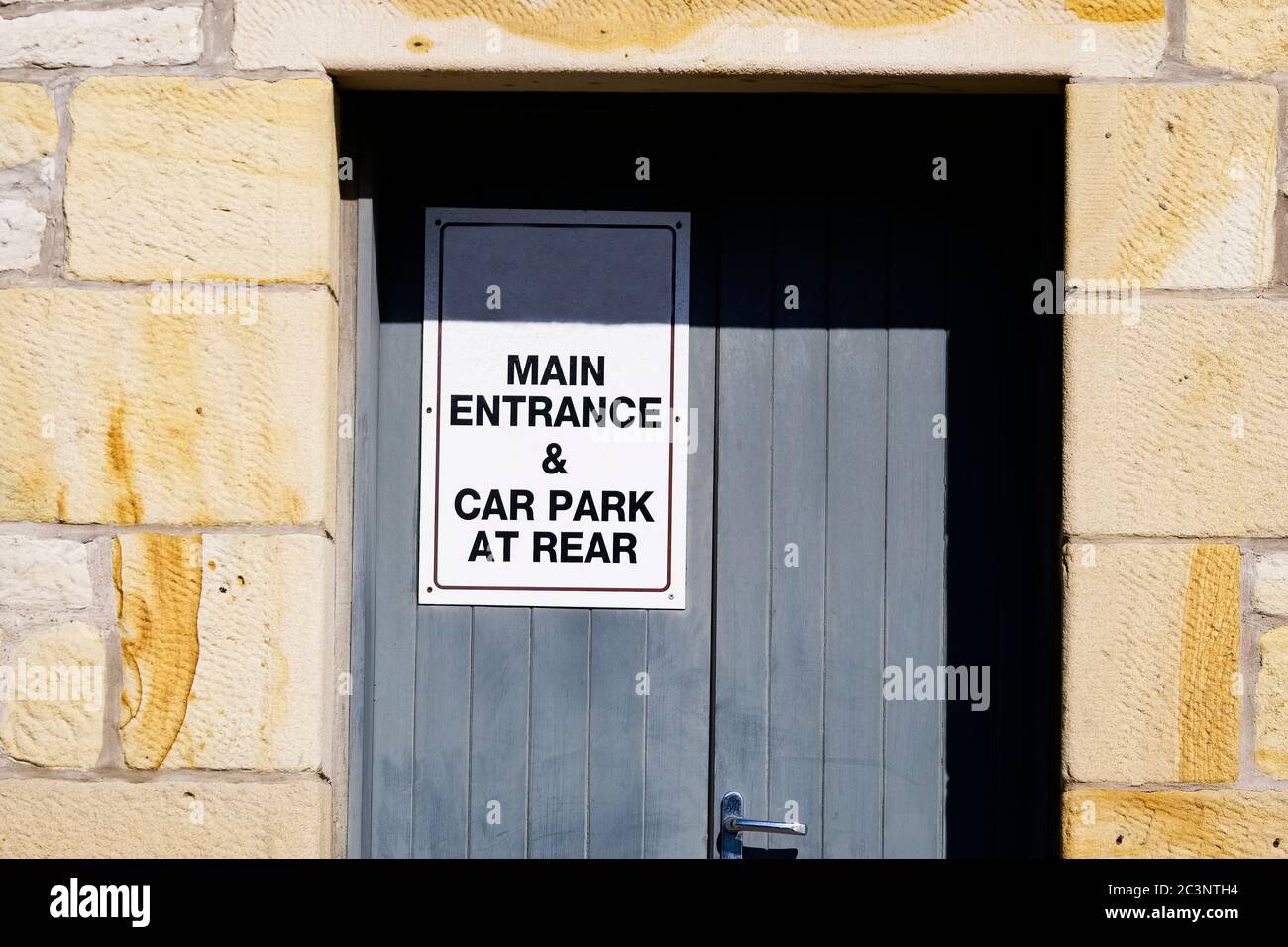 Main entrance and car park at rear sign Stock Photo - Alamy