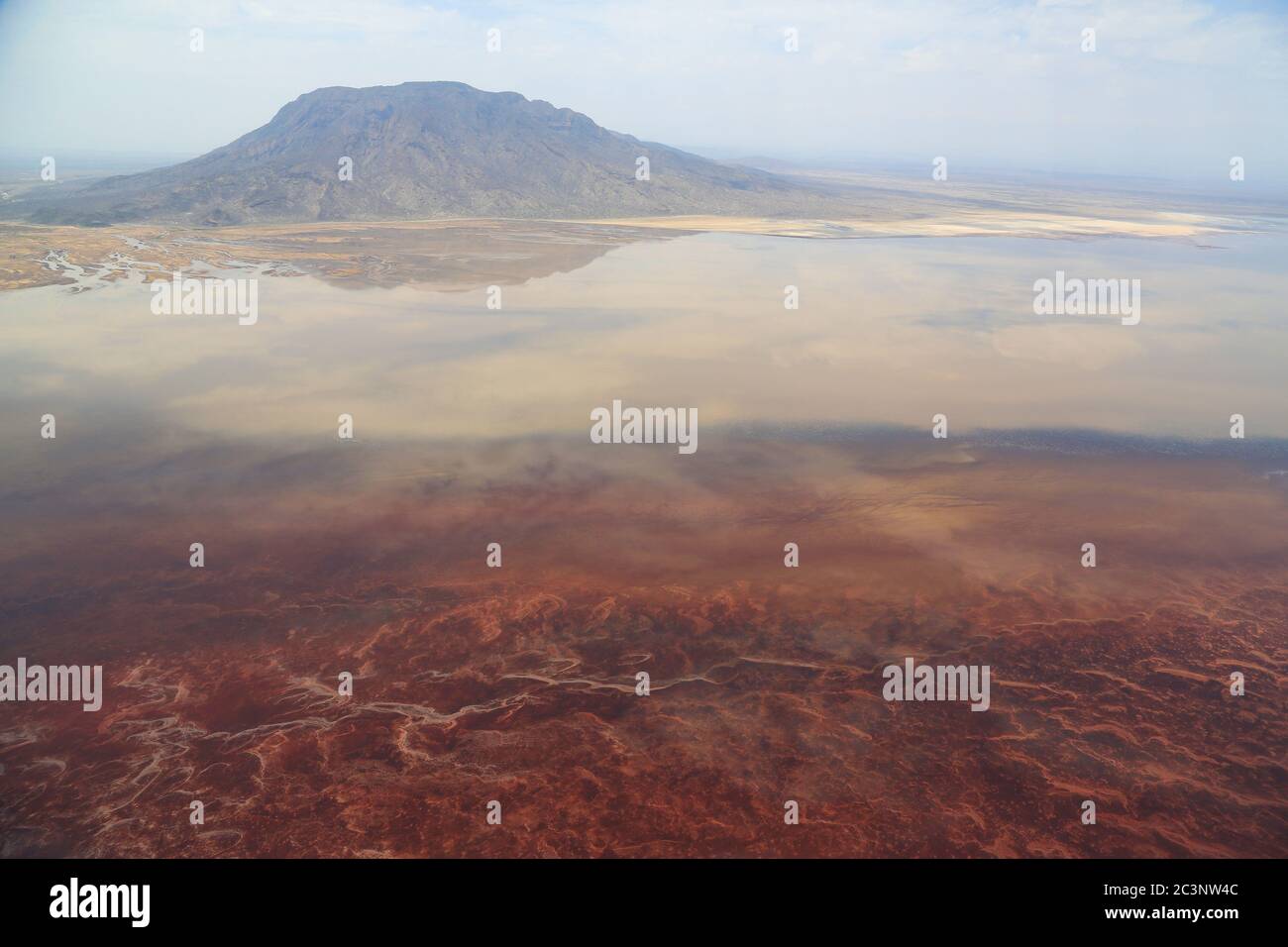 Aerial view of the salt pan and mineral crust with red algae of Lake Natron, in the Great Rift Valley, between Kenya and Tanzania. Stock Photo