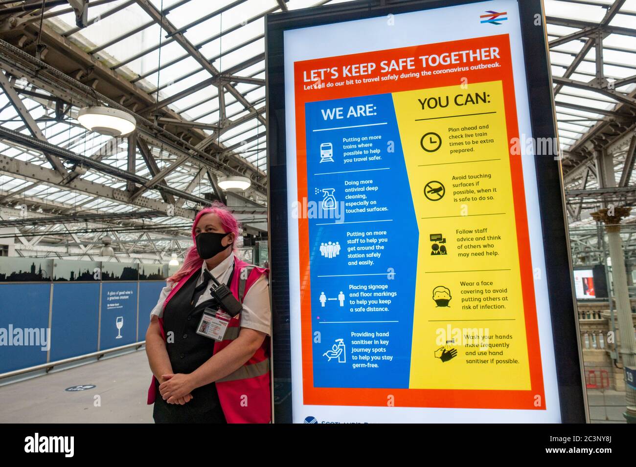 Edinburgh, Scotland, UK. 21 June, 2020. On Monday 22 June it will be mandatory for passengers to wear face coverings when travelling on railways in Scotland. Waverley Station in Edinburgh is preparing by installing warning signs and advisory notices through the station. Many customer service assistants are also on duty to advise the travelling public.   Iain Masterton/Alamy Live News Stock Photo