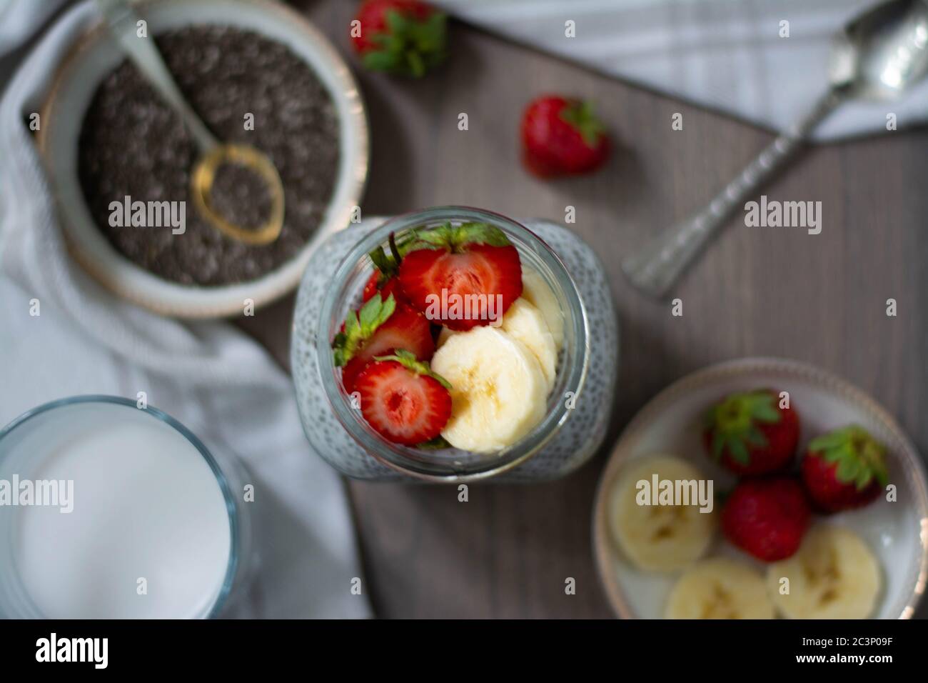 Healthy vegan chia seed pudding in a mason jar topped with strawberry