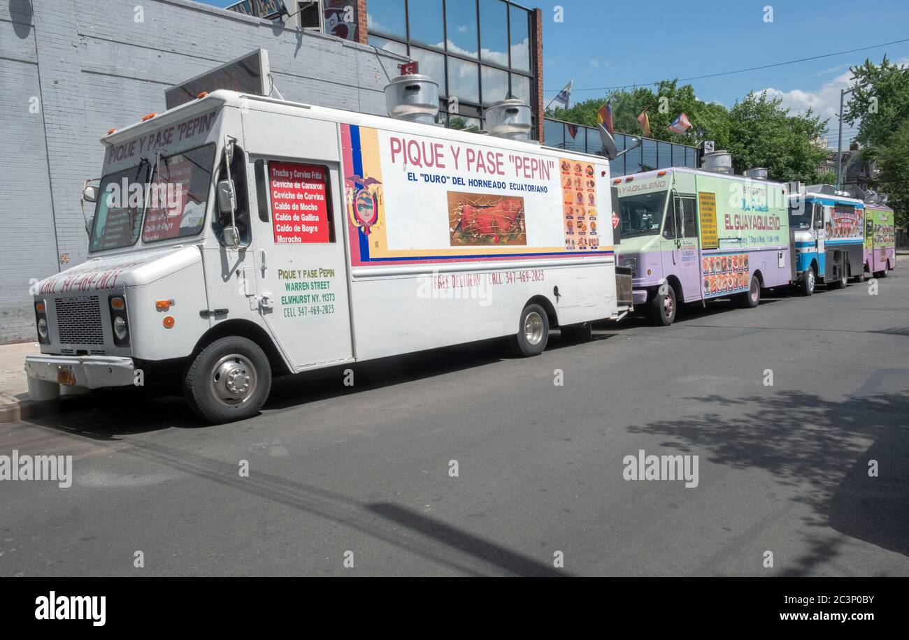 Four Ecuadorian food trucks doing business on Warren St. of Roosevelt Avenue in East Jackson Heights, Queens, New York. Stock Photo