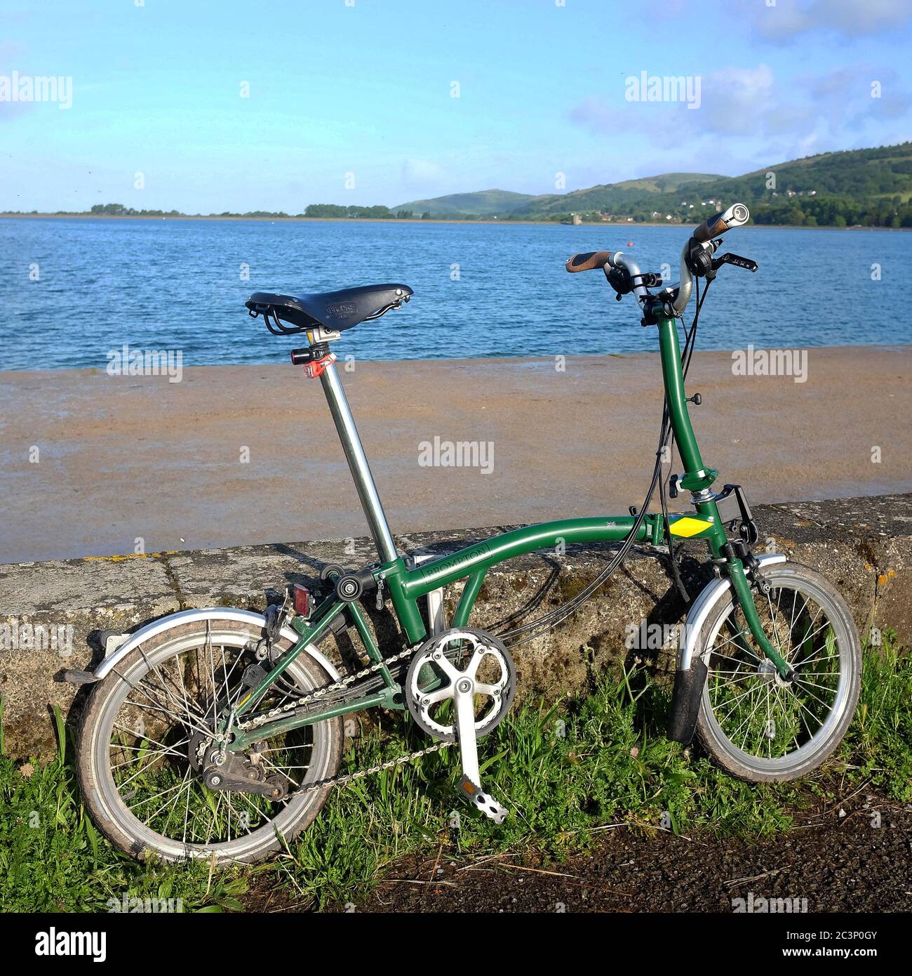 June 2020 - Green Brompton folding bicycle beside Cheddar reservoir. Stock Photo