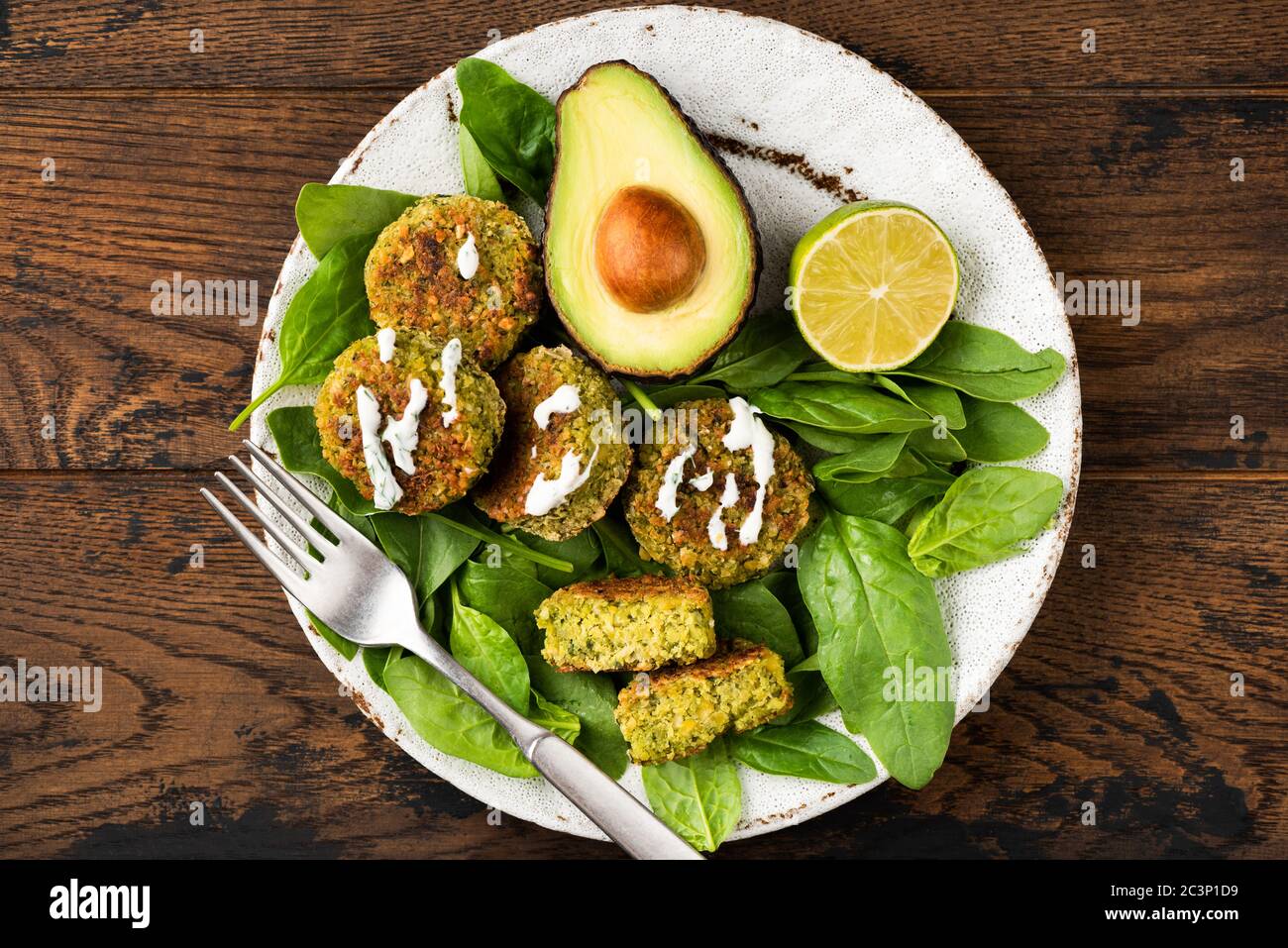 Chickpea falafel with spinach and avocado on plate. Healthy vegan