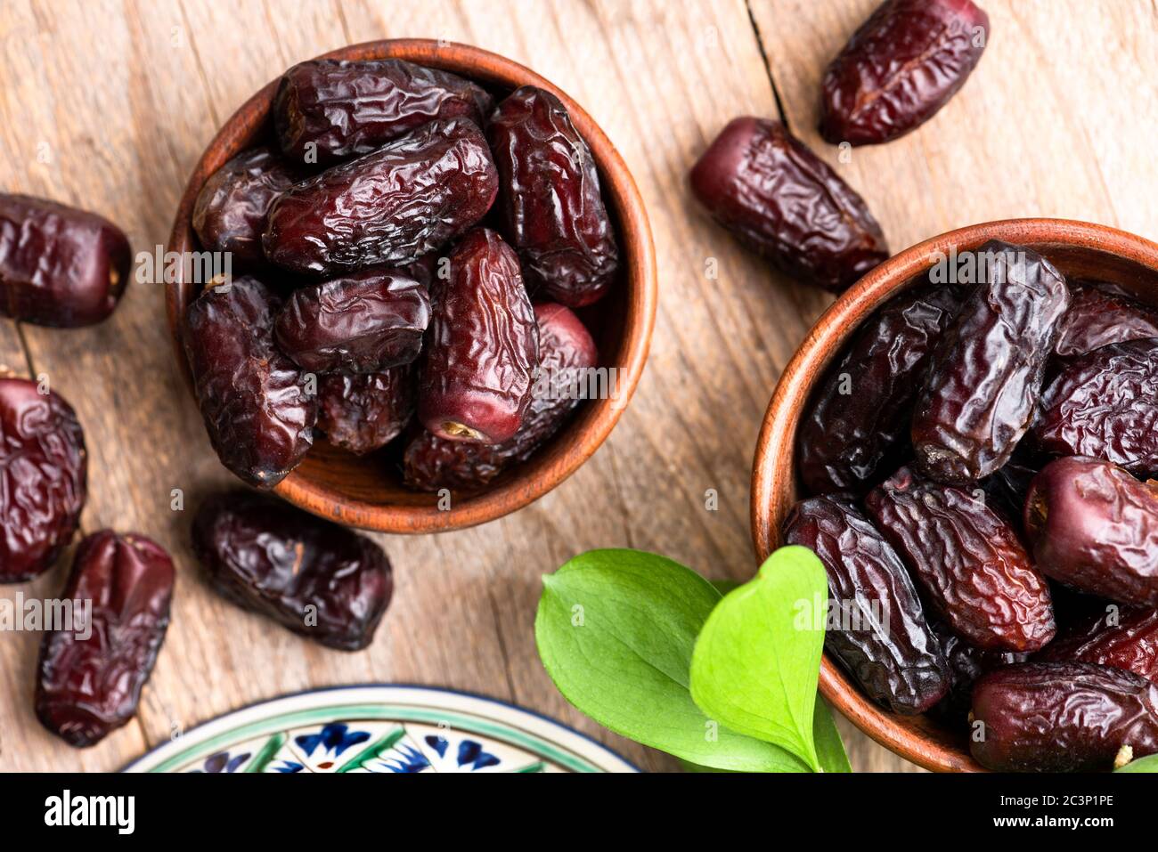 Dry date fruit in bowl on wooden table background. Vegan, vegetarian arabic food Stock Photo