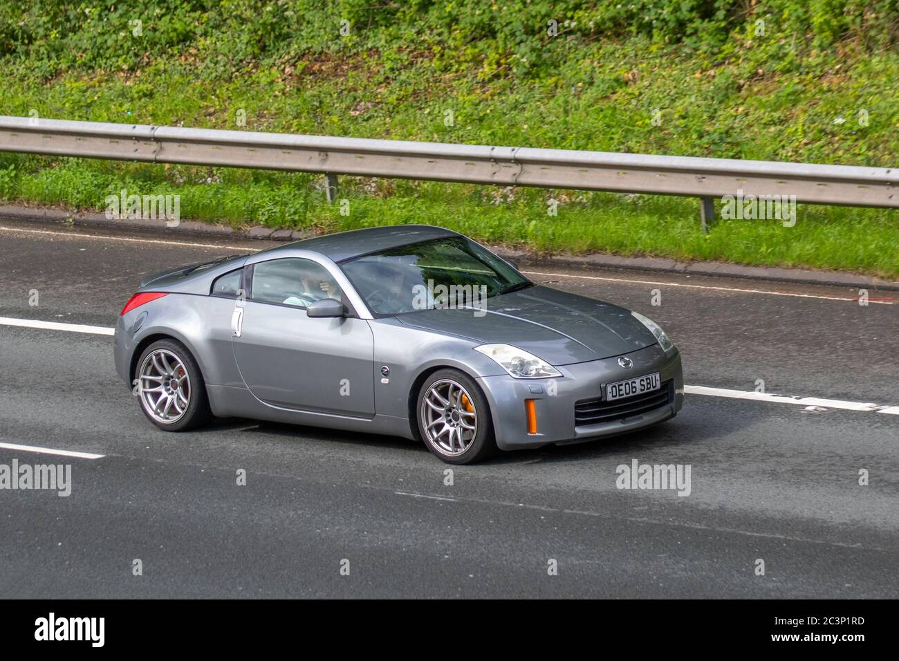 2006 silver Nissan 350 Z; Vehicular traffic moving vehicles, cars driving vehicle on UK roads, motors, motoring on the M6 motorway highway Stock Photo