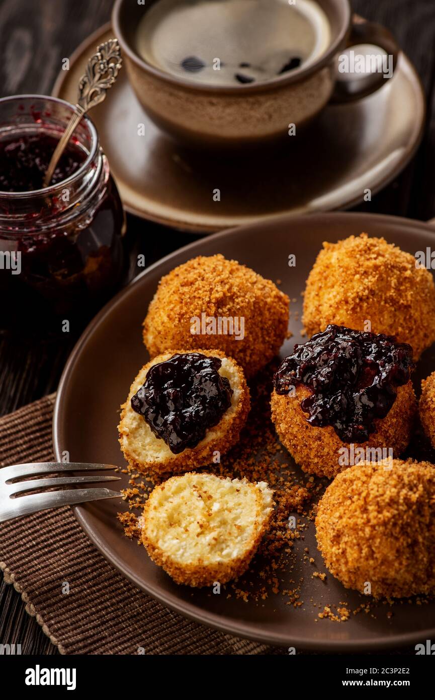 Homemade cottage cheese balls, hungarian sweet dessert served with berry jam. Stock Photo