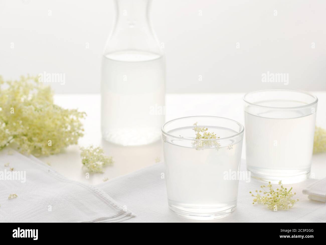 Elderberry flowers beverage on the drinking glass . Summer Healthy natural  flavored drink. Horizontal orientation. Stock Photo