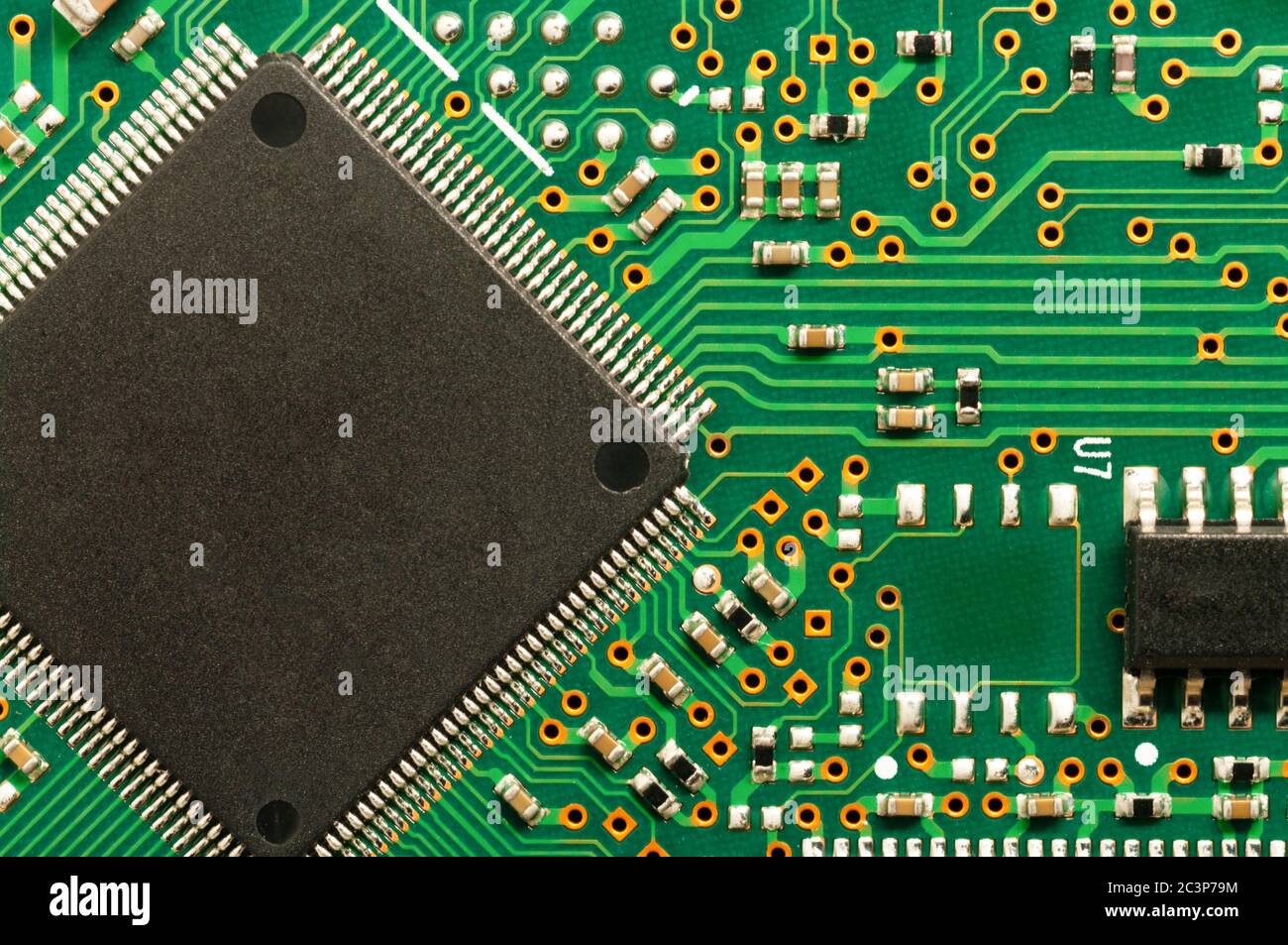 Close-up of electronic circuit board PCB with microchip, processor, integrated circuits, resistances and electronic connections. Stock Photo