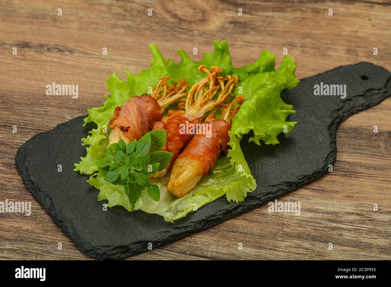 Roasted Enoki Mushrooms With Bacon Served Basil Leaves Stock Photo Alamy