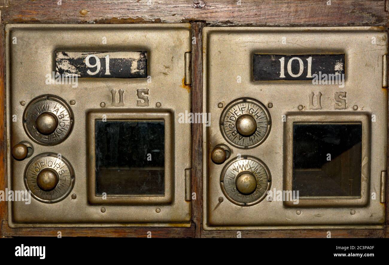 Close up of two post office boxes with combination dials on them Stock