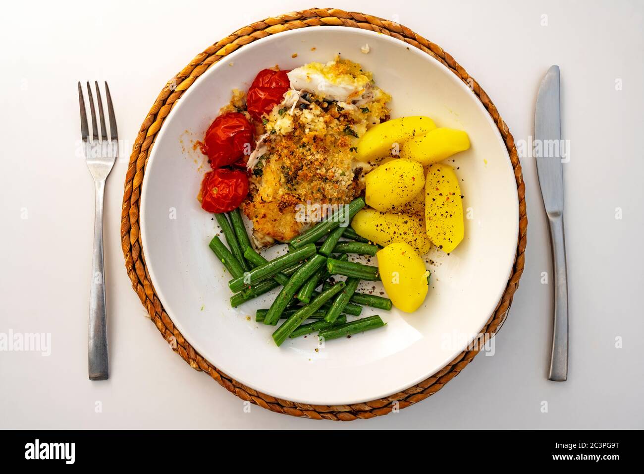 Parsley-crusted cod, runner beans and boiled potatoes Stock Photo