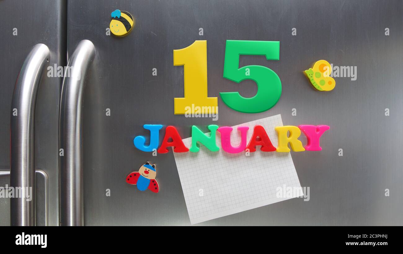 January 15 calendar date made with plastic magnetic letters holding a note of graph paper on door refrigerator Stock Photo