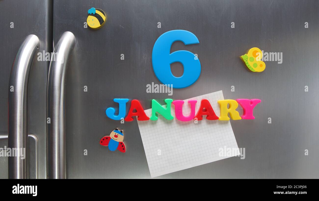 January 6 calendar date made with plastic magnetic letters holding a note of graph paper on door refrigerator Stock Photo