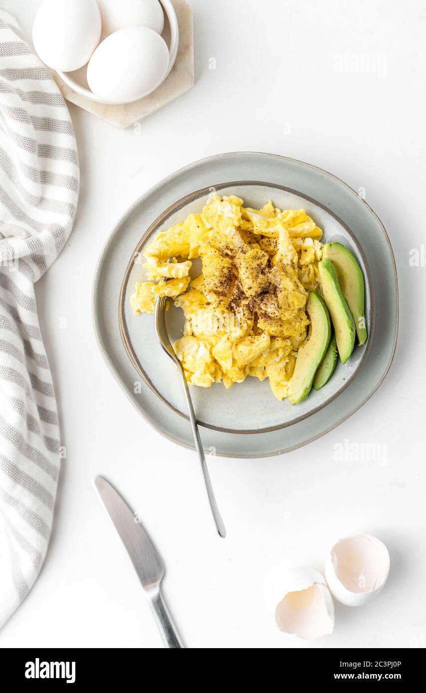 Scrambled eggs with avocados for breakfast Stock Photo - Alamy